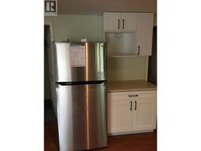 Coquitlam apartment for rent - A stainless steel refrigerator with a magnet on the door and a paper attached to it.