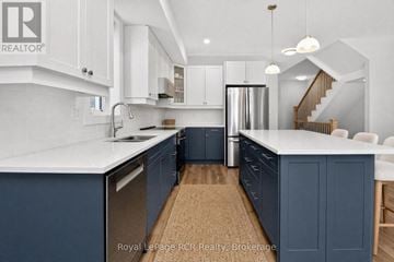 Blue Mountains apartment for rent - A kitchen with white cabinets and a blue island.