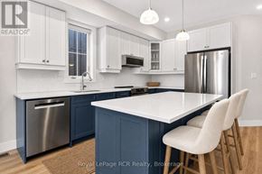 Blue Mountains apartment for rent - A kitchen with white cabinets and a large island.