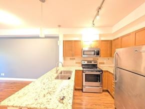 Surrey apartment for rent - A kitchen with a granite counter top and stainless steel appliances.