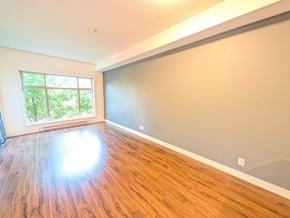 Surrey apartment for rent - A room with wooden flooring and a large window.