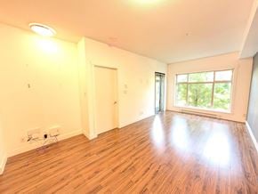 Surrey apartment for rent - A room with wooden flooring and a window showing greenery outside.