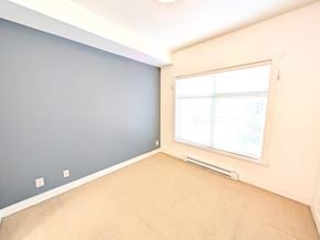 Surrey apartment for rent - A room with a window and a carpeted floor.