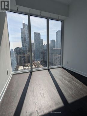 Toronto (Church-Yonge Corridor) condo for rent - A room with a view of the city skyline through large windows.