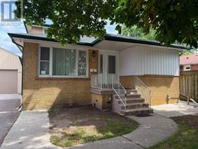 Brampton (Brampton North) apartment for rent - A house with a white siding and a brick foundation is for sale.