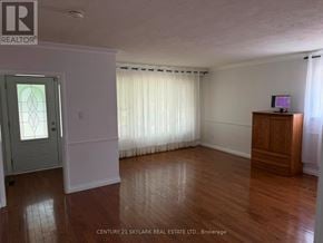 Brampton (Brampton North) apartment for rent - A room with wooden floors and a white door.