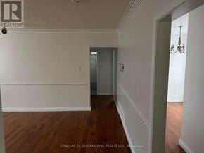 Brampton (Brampton North) apartment for rent - A hallway with wooden floors and white walls.