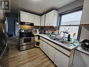Windsor apartment for rent - A kitchen with white cabinets and a stainless steel oven.