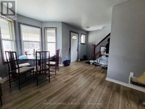 Windsor apartment for rent - A room with wooden floors and a dining table set up with chairs.