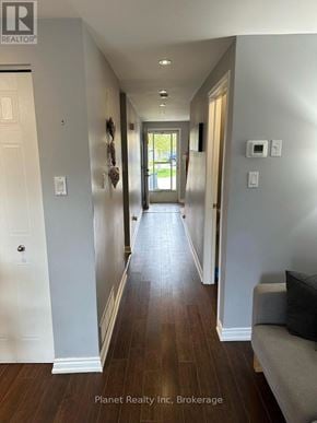 Guelph (Kortright West) townhouse for rent - A long hallway with a couch and a door on the left.
