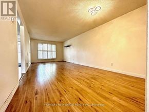 Markham (Markville) apartment for rent - A spacious room with wooden flooring and a window.