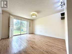 Markham (Markville) apartment for rent - A room with wooden flooring and a sliding glass door leading to a backyard.