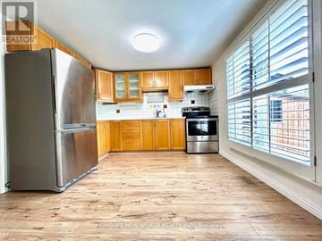 Markham (Markville) apartment for rent - A kitchen with wooden cabinets and a stainless steel refrigerator.