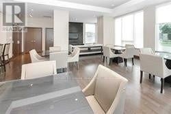 Mississauga (Fairview) condo for rent - A living room with white furniture and a glass table.