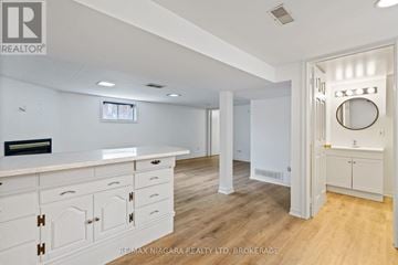 St. Catharines (Downtown) apartment for rent - A white kitchen with a counter top and cabinets.