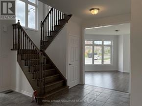 Caledon apartment for rent - A Royal LePage Signature Realty Brokerage logo is on the wall above a staircase.