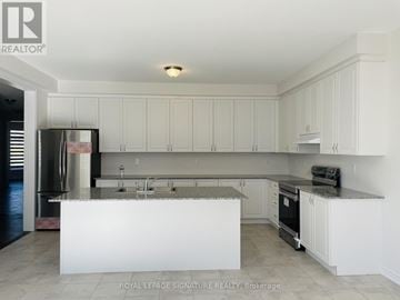 Caledon apartment for rent - A kitchen with white cabinets and a white island.