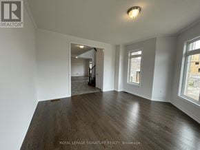Caledon apartment for rent - A spacious room with wooden flooring and white walls.
