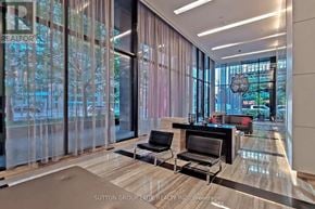 Toronto (Church-Yonge Corridor) condo for rent - A modern waiting area with a glass wall and two black chairs.