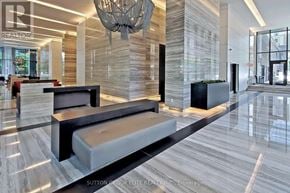Toronto (Church-Yonge Corridor) condo for rent - A modern lobby with a marble floor and a large chandelier.