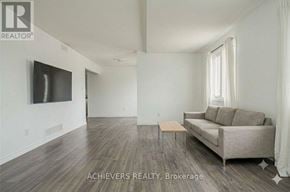 Barrie (Holly) condo for rent - A living room with a couch, a television, and a window.