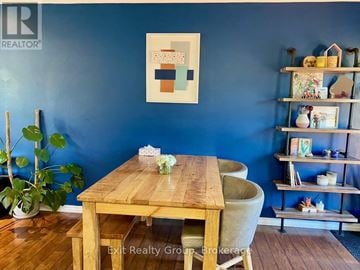Quinte West (Trenton Ward) apartment for rent - A dining room with a wooden table and chairs.
