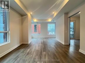 Toronto (Waterfront Communities) condo for rent - A spacious room with wooden flooring and a large window.