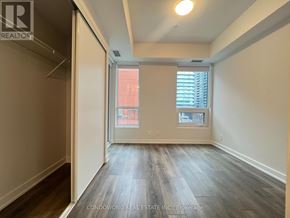 Toronto (Waterfront Communities) condo for rent - A room with a window and a view of a building outside.