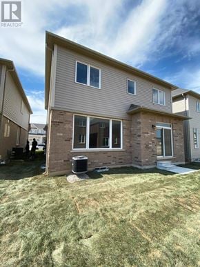 Brantford apartment for rent - A house with a brown and beige exterior is shown with a blue sky in the background.