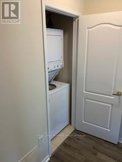 Oshawa (Vanier) multi-family for rent - A small laundry room with a washer and dryer.