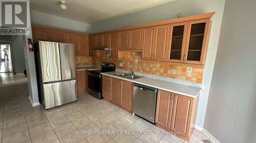 Mississauga (East Credit) apartment for rent - A kitchen with wooden cabinets and a tiled backsplash.