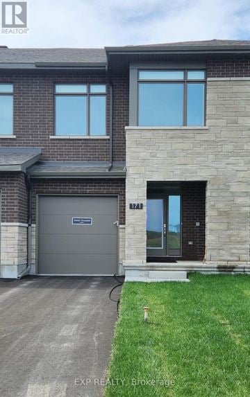 Ottawa townhouse for rent - A house with a grey garage door and a black front door.