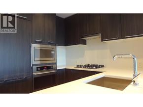 Vancouver apartment for rent - A modern kitchen with dark wood cabinets and stainless steel appliances.