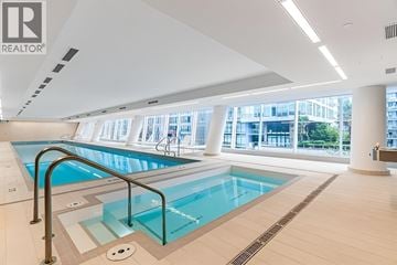 Vancouver apartment for rent - A large indoor swimming pool with a glass barrier.