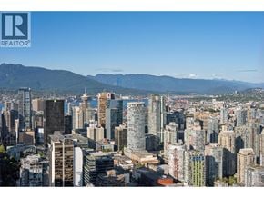 Vancouver apartment for rent - A cityscape with a mountain range in the background.