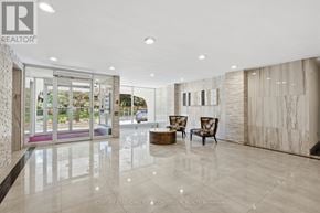 Toronto (Tam O'shanter-Sullivan) condo for rent - A spacious lobby with a marble floor and a glass wall leading to a balcony.