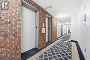 Toronto (Tam O'shanter-Sullivan) condo for rent - A hallway with brick walls and white doors.