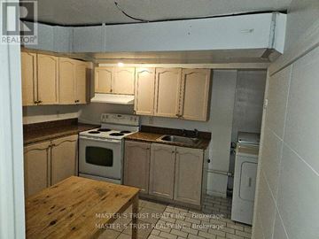 Toronto (Don Valley Village) apartment for rent - A kitchen with wooden cabinets and a wooden table.