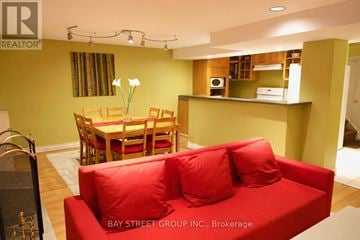 Markham (Royal Orchard) apartment for rent - A living room with a red couch and a dining table.