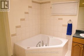 Markham (Royal Orchard) apartment for rent - A white bathtub with a blue towel hanging on the wall.