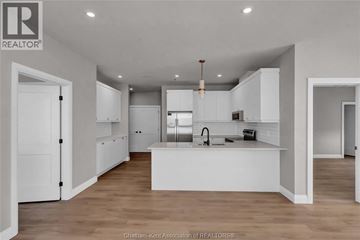Blenheim apartment for rent - A modern kitchen with white cabinets and a central island.