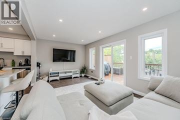 Waterloo townhouse for rent - A modern living room with a white sofa set and a television.