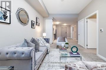Guelph (St. Patrick's Ward) condo for rent - A well-lit, modern living room with a grey sofa and a glass coffee table.