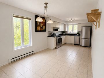 Gatineau (Gatineau) apartment for rent - A kitchen with white cabinets and a tiled floor.