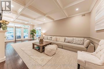 Toronto (St. Andrew-Windfields) apartment for rent - A spacious living room with a large couch and a coffee table.