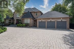 Toronto (St. Andrew-Windfields) apartment for rent - A large house with a driveway in front of it.