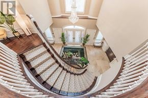 Toronto (St. Andrew-Windfields) apartment for rent - A view of a staircase from above with a chandelier hanging from the ceiling.
