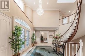 Toronto (St. Andrew-Windfields) apartment for rent - A spacious foyer with a staircase and a chandelier.