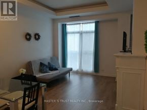 Toronto (Church-Yonge Corridor) condo for rent - A living room with a grey couch, a glass table, and a fireplace.