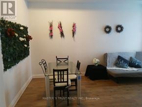 Toronto (Church-Yonge Corridor) condo for rent - A living room with a grey couch, a black table, and a green plant on the wall.